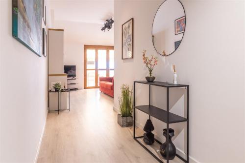 a living room with a mirror on the wall at IseoLakeRental - Casa Alto Sebino in Riva di Solto