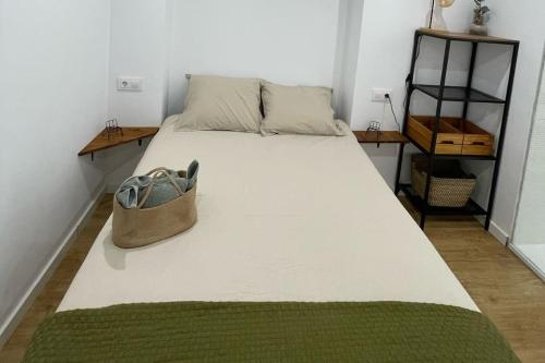 a bed with a purse sitting on top of it at Unique apartment in Coruña Old Town in A Coruña