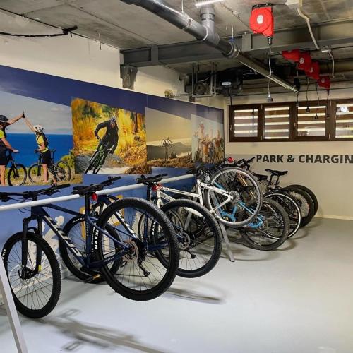 a bunch of bikes are lined up in a room at Hotel Il Cervo, SPA & Wellness, Bike Hotel in Tarvisio