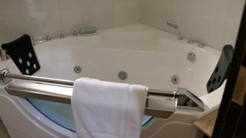 a bath tub in a bathroom with a towel at Nisa Wellness Retreat in Abuja