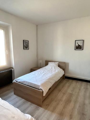 a bedroom with a large bed and a wooden floor at Le Clos de Canet in Canet d'Aude