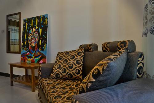 a living room with a couch and a table at Cocolala Beach House in Nungwi