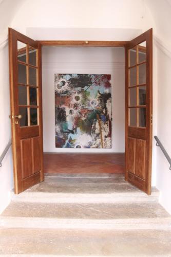 an open door in a room with a painting on the wall at Convento da Orada - Monsaraz in Monsaraz