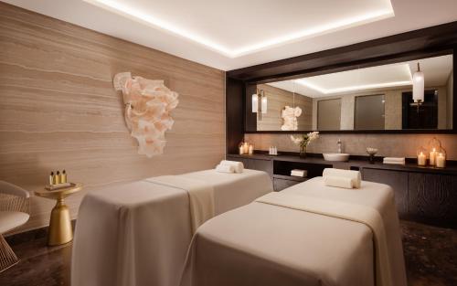 a room with two tables and a mirror at The Ritz-Carlton, Baku in Baku