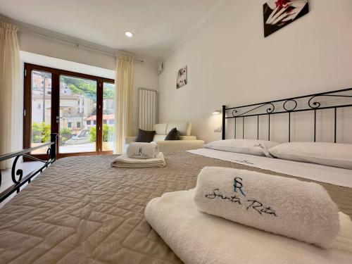 a large bedroom with two beds with towels on them at Appartamenti Santa Rita in Maiori