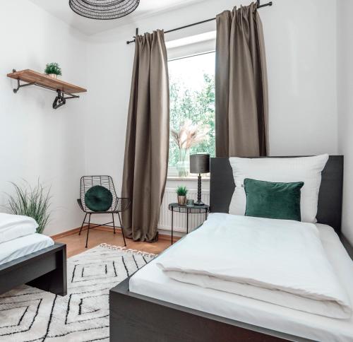 a bedroom with a large bed and a window at Dream for 4 - Smart TV in Krefeld