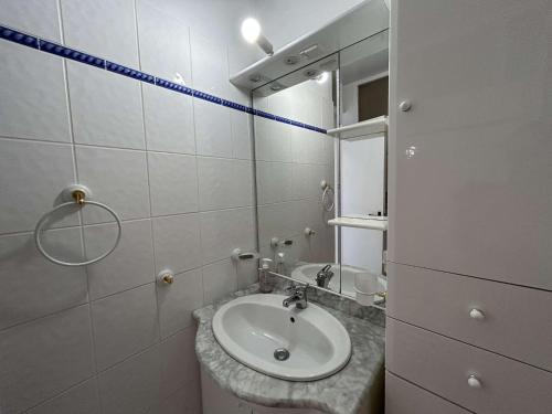 a bathroom with a sink and a mirror at Studio Cabine 4 Couchages avec Balcon et Parking - Saint-Jean-de-Monts - FR-1-224C-18 in Saint-Jean-de-Monts