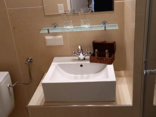 a bathroom with a white sink and a toilet at Gästehaus auf der Kunstmeile in Krems an der Donau