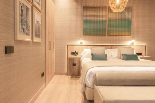 a hotel room with two beds and a table at The Valentia Corretgería in Valencia