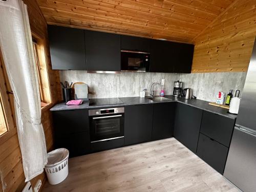 a kitchen with black cabinets and a counter top at Faleide Panorama in Stryn