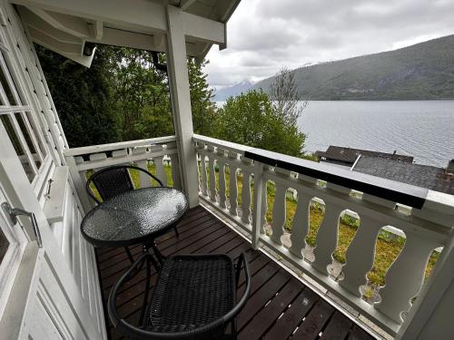 a porch with a chair and a view of a lake at Faleide Panorama in Stryn