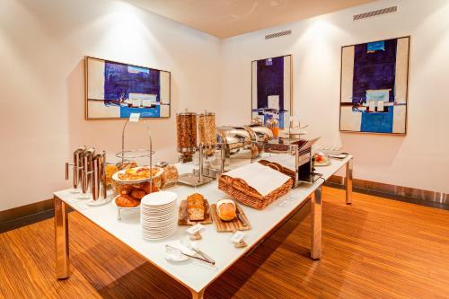 a table with a bunch of food on it at Mantra Charles Hotel in Launceston