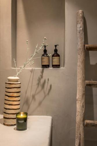 two bottles of essential oils sitting on a shelf at Verina Astra in Artemonas