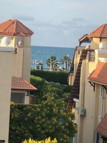 a view of the ocean from between two buildings at فيلا الساحل الشمالى Villa North coast Marseilia Beach 3 " Families Only" in Alexandria