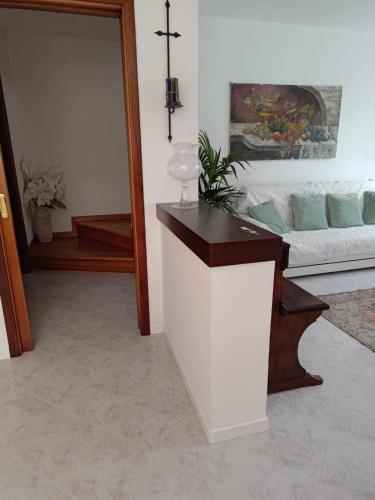 a living room with a counter and a cross on the wall at Traghetto vecchio house in Cavallino-Treporti