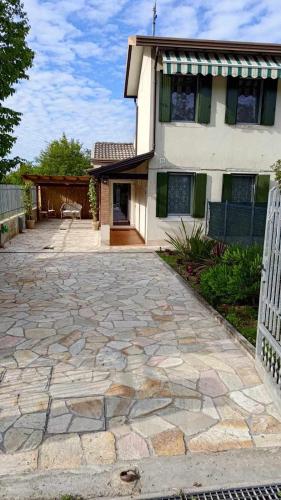a stone driveway in front of a house at Traghetto vecchio house in Cavallino-Treporti
