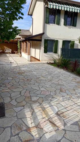 a stone driveway in front of a house at Traghetto vecchio house in Cavallino-Treporti