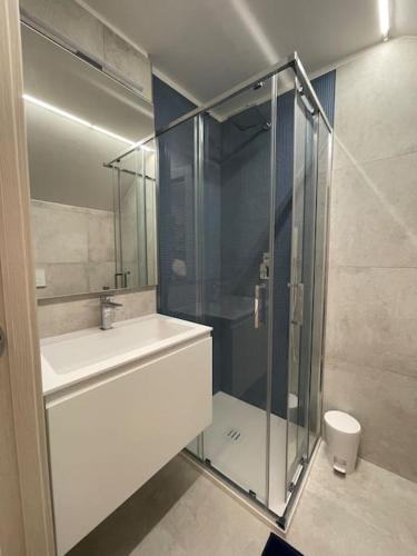 a bathroom with a glass shower and a sink at Le Vele Luxury Mini Apartment in Chioggia