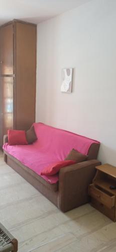 a bed in a room with a pink blanket at EKTOR APARTMENTS @SWIMMING POOL in Sidari