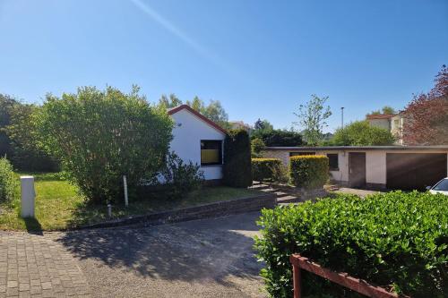 a house with a driveway in front of it at Bungalow "Refugium" in Ostseebad Sellin