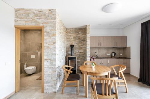 a kitchen and dining room with a wooden table and chairs at Reketijos Dvaras in Reketija