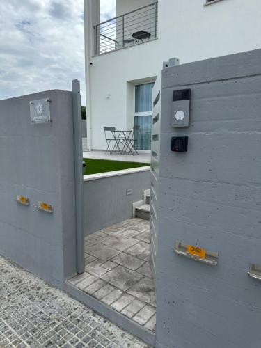 a wall with a gate in front of a building at Artemisia Home in Olbia
