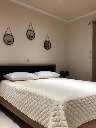 a bedroom with a bed with two mirrors on the wall at Frosos house in Kefalos
