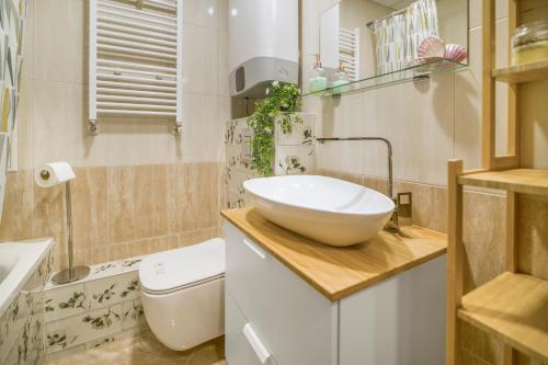 a bathroom with a bowl sink and a toilet at Top Central Maisonette with Underground parking in Sofia