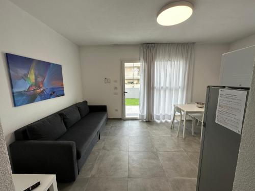 a living room with a couch and a table at Artemisia Home in Olbia