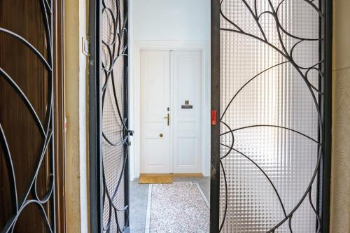 a door leading to a hallway with wrought iron at Central Living Apartments - Unteres Belvedere in Vienna