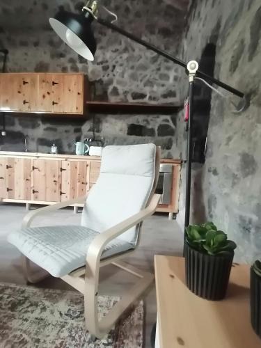 a white chair sitting next to a desk with a lamp at Casa C'alma in Ponta Delgada