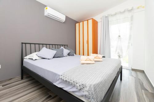 Schlafzimmer mit einem Bett mit weißer Bettwäsche und einem Fenster in der Unterkunft House Coso in Podšpilje