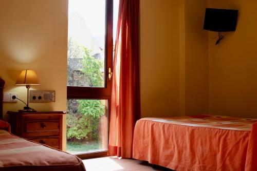 A bed or beds in a room at Pensio La Creu