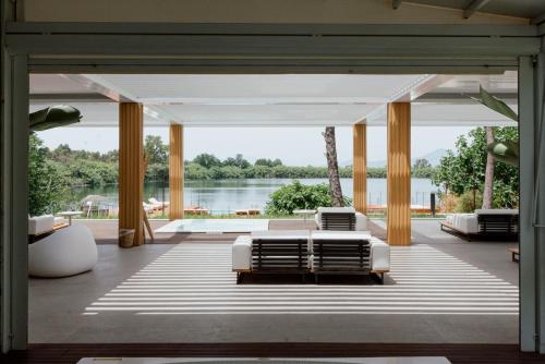a living room with couches and a view of the water at Plana Resort & SPA in Castel Volturno