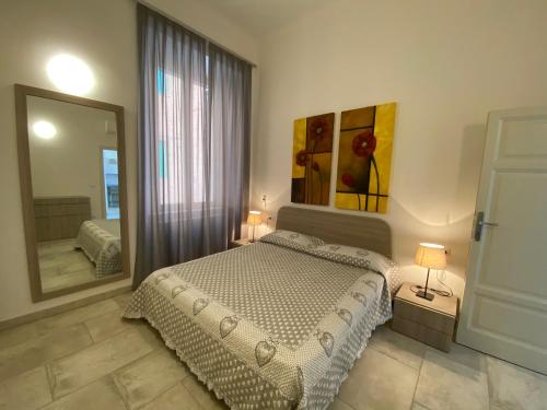 a bedroom with a bed and a large mirror at Villa Rosy in San Vincenzo