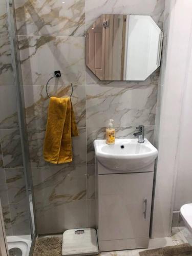 a bathroom with a shower and a sink and a mirror at Two Bedroom House Birchington ct79rn in Birchington