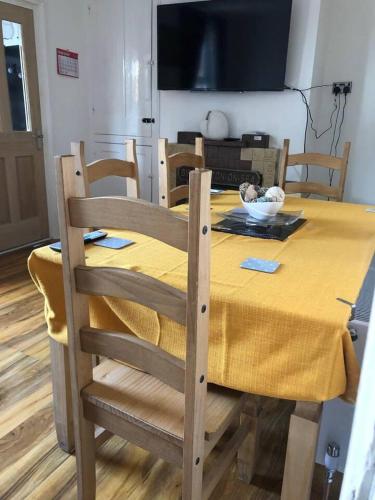 a dining room table with a yellow table cloth at Two Bedroom House Birchington ct79rn in Birchington