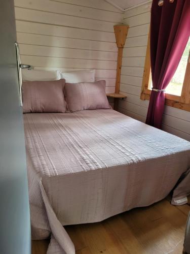 a large bed in a room with a window at Chalet Climatisé SANTA MARIA à Bonifacio in Bonifacio