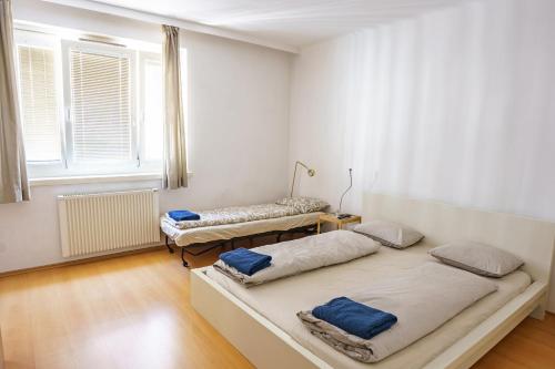 een kamer met 2 bedden en een raam bij Vienna Living Apartments - Mühlfeldgasse in Wenen