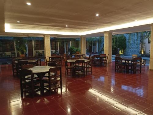 a restaurant with tables and chairs in a room at Catur Adi Putra in Denpasar