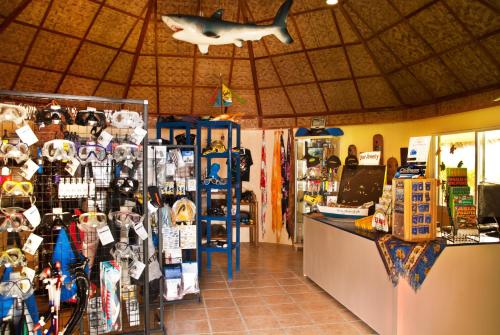 a store with a shark hanging from the ceiling at Easy Diving and Beach Resort in Sipalay