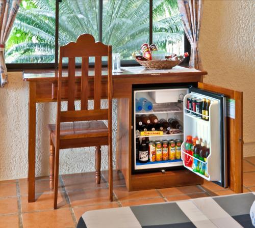 a small refrigerator with a chair and a table at Easy Diving and Beach Resort in Sipalay