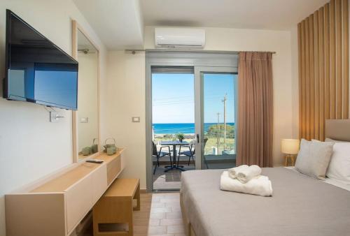 a hotel room with a bed and a view of the ocean at Melilia luxury villa in Gennadi
