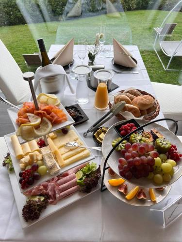 a table topped with plates of food and fruit at Das Bergschlösschen in Bamberg
