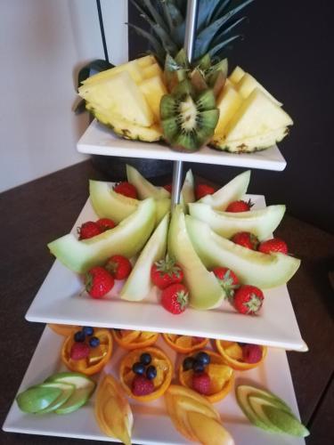 a three tiered display of fruit on three white plates at Das Bergschlösschen in Bamberg