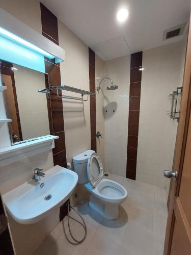a bathroom with a white toilet and a sink at V Check inn Sukhumvit 22 in Bangkok