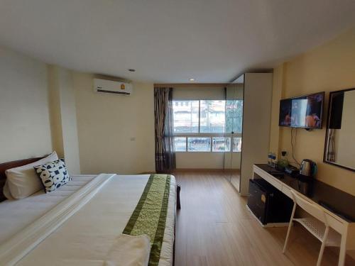 a hotel room with a bed and a television at V Check inn Sukhumvit 22 in Bangkok