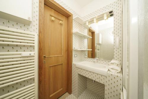 a bathroom with a sink and a mirror at iFlat Apartment Madonna di Campiglio Casa di Betti in Madonna di Campiglio