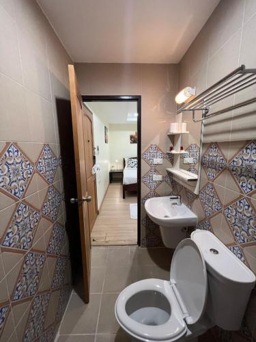 a bathroom with a toilet and a sink at V Check inn Sukhumvit 22 in Bangkok