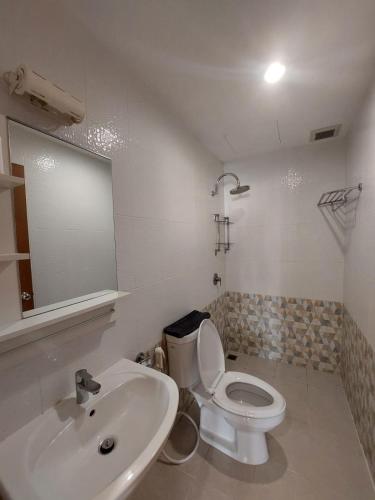 a bathroom with a white toilet and a sink at V Check inn Sukhumvit 22 in Bangkok